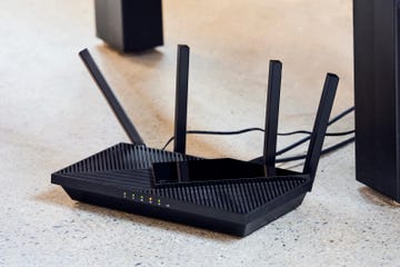 wireless router with visible antennas and indicator lights