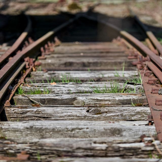 a photo taken on april 9, 2021 shows old train tracks leading past a former canteen building of ss guards at the former nazi germany death camp auschwitz birkenau, in oswiecim, poland   a polish foundation hopes to restore a canteen where ss guards ate and sought distraction after long days of killing at the former nazi germany death camp auschwitz birkenau, to serve as a reminder of the banality of evil built in march 1942 at auschwitz    europe's largest death factory    the massive dining hall could house up to 4,000 people after the war it served as a cereal warehouse before it was abandoned and gradually fell into ruin   to go with afp story by stanislaw waszak photo by bartosz siedlik  afp  to go with afp story by stanislaw waszak photo by bartosz siedlikafp via getty images