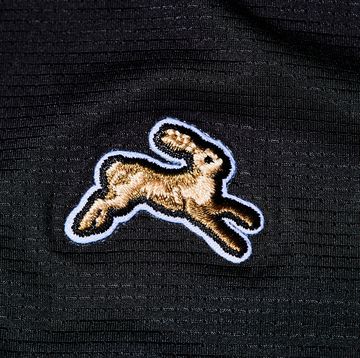 the tracksmith logo on black fabric