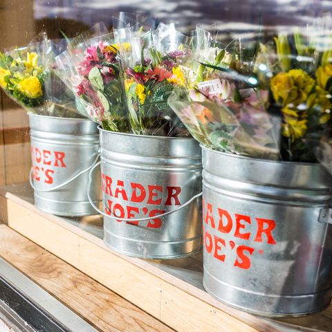 fairfax buckets of flowers with trader joes signs viewed from outside of store