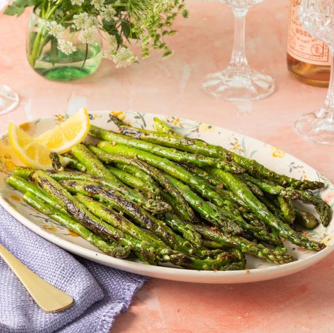 sauteed asparagus on platter with lemons