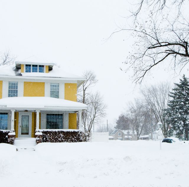 winterization of home, winter energy saving tips 2020, traditional home in a snow storm