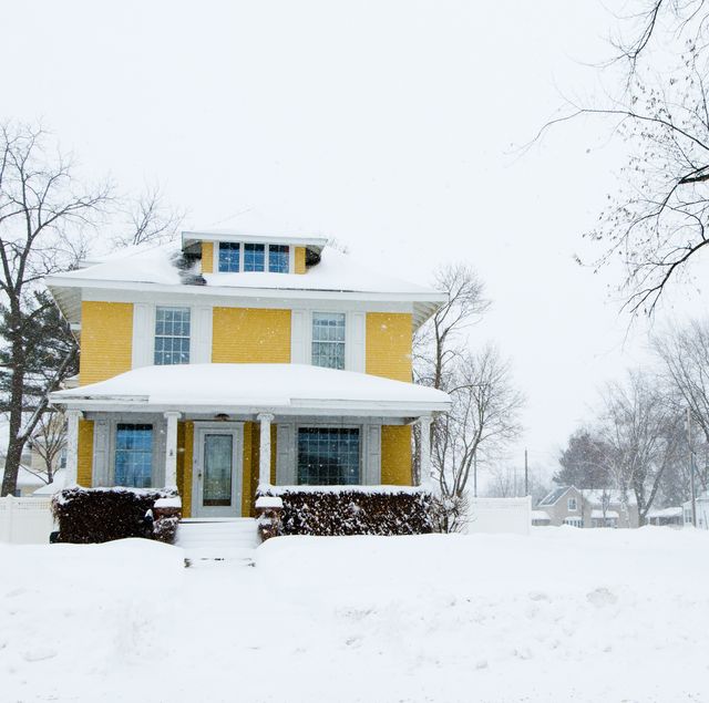 winterization of home, winter energy saving tips 2020, traditional home in a snow storm