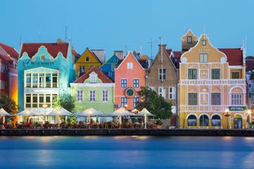 traditional multi colored town houses on waterfront at dusk, punda, willemstad, curacao, caribbean