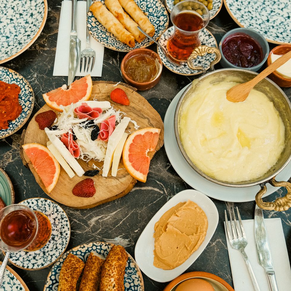 traditional turkish breakfast. table full of plates with snacks. cheese plate.