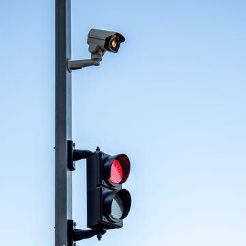 Traffic control security camera and traffic light on a blue sky. traffic control security camera and traffic light on a blue sky