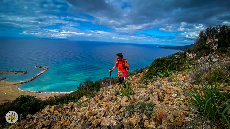 a person walking on a rocky hill