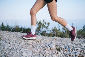 trail runner ascends mountain trail