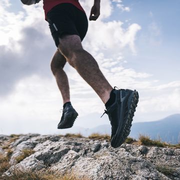 trail runner ascends rocky mountain ridge