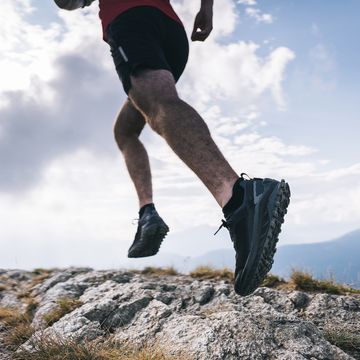 trail runner ascends rocky mountain ridge