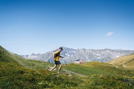 trail runner bounds along mountain trail