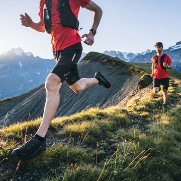 trail runners ascend mountain ridge