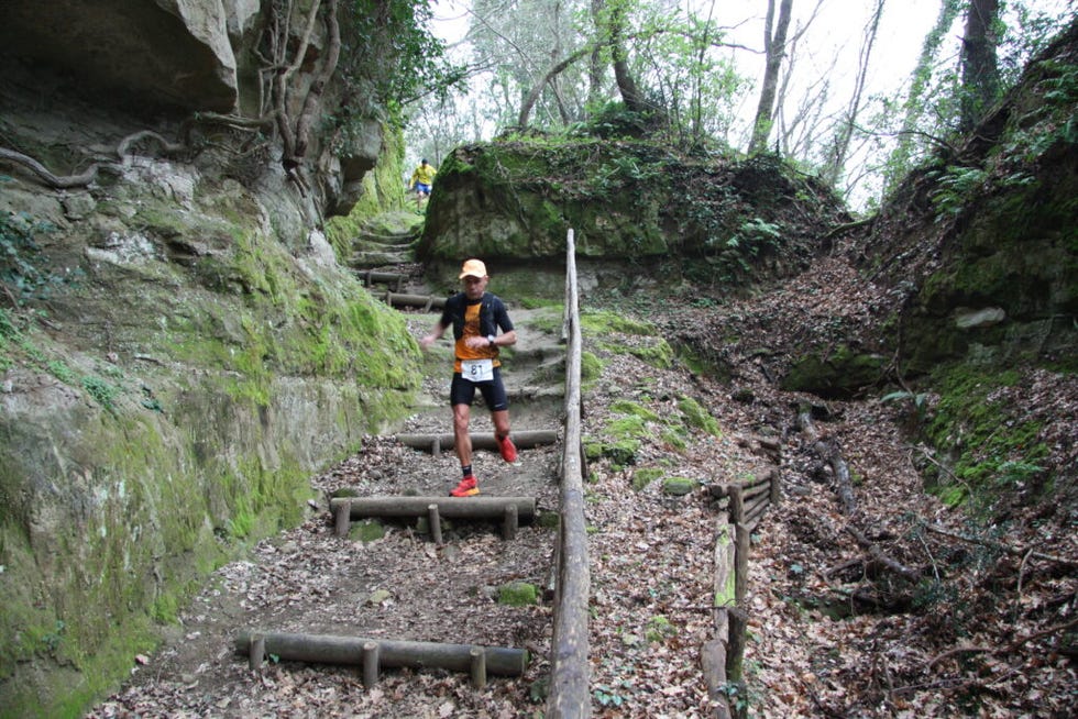 a person running on a path in a rocky area