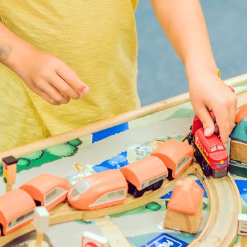 kid playing with train table