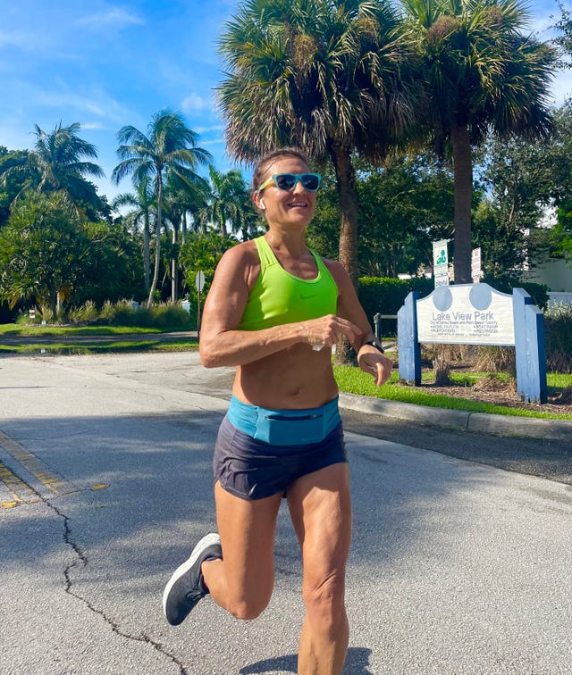a person jogging outdoors near a park sign