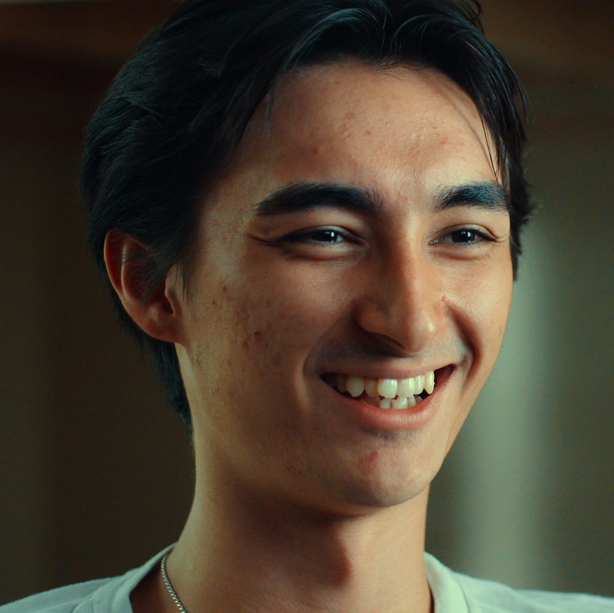 Falcon Heene in 'Trainwreck: Balloon Boy' a young man smiles as he looks to the right, only part of his light colored shirt is visible cr. courtesy of netflix © 2025