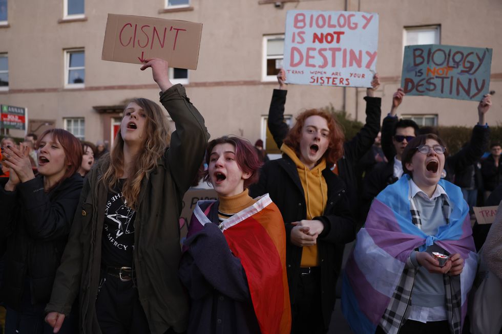 trans rights activists protesting outside a gender identity talk in edinburgh, scotland