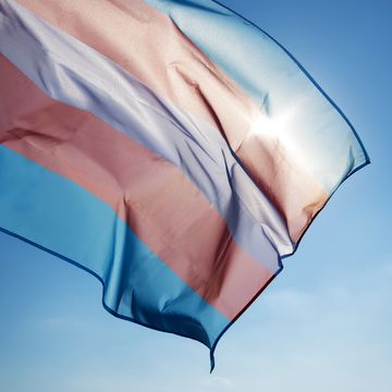 transgender pride flag waving on the blue sky