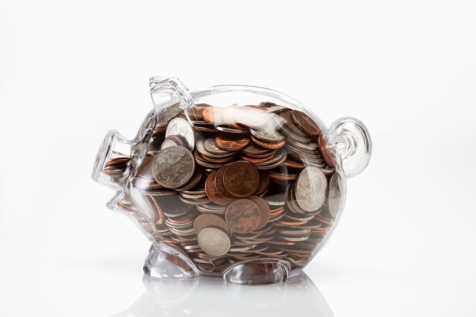 transparent piggy bank full of coins