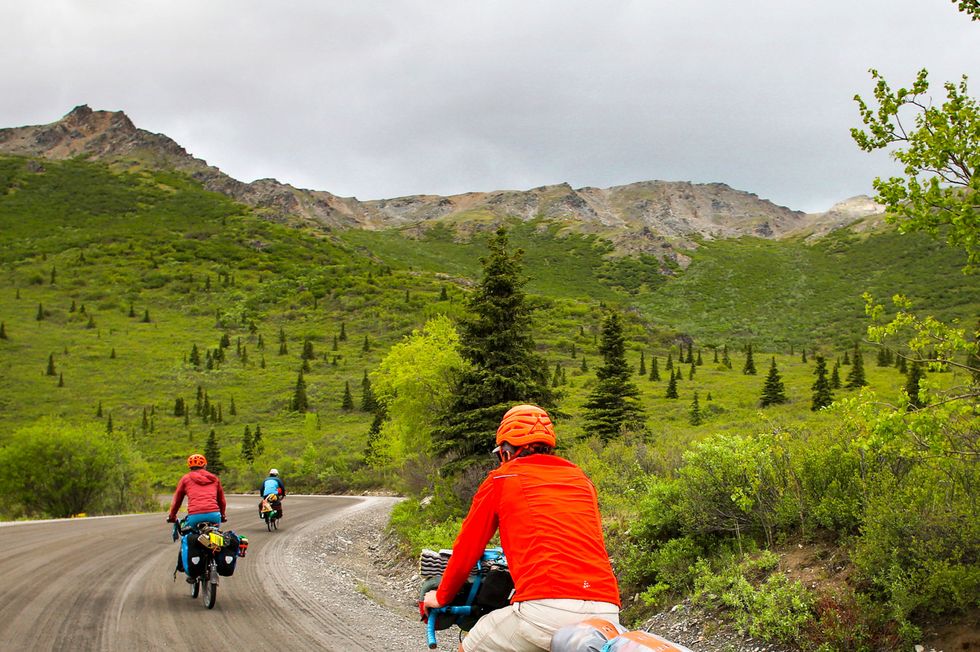 cyclists on a gravel road at denali national park riding