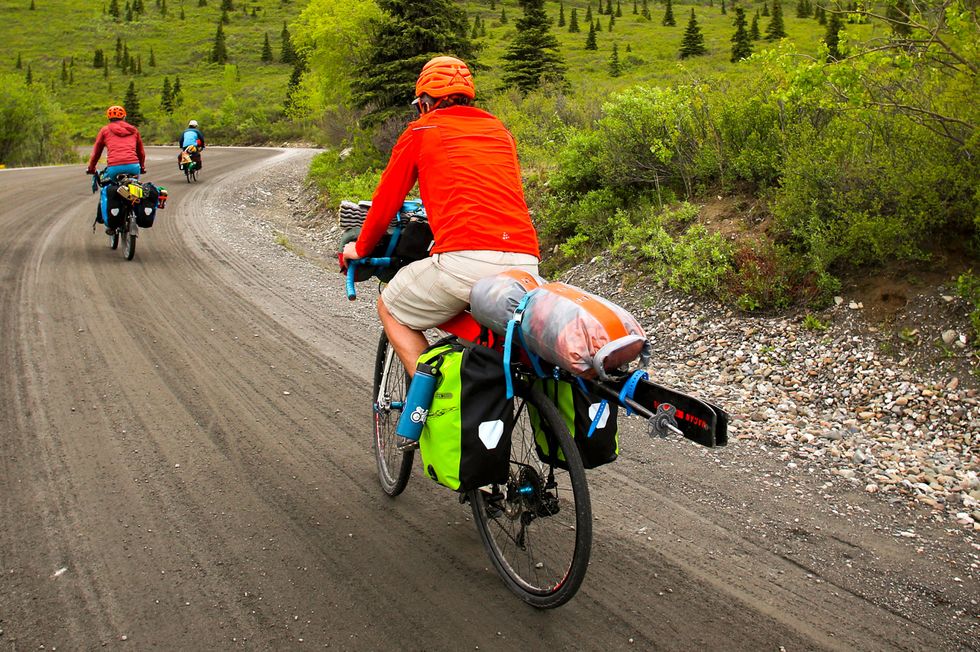 cyclists on a gravel road at denali national park riding