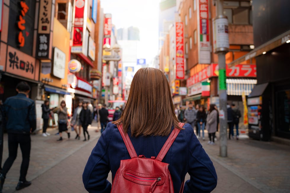 traveler in shinjuku street main shopping in nishishinjuku, tokyo, japan