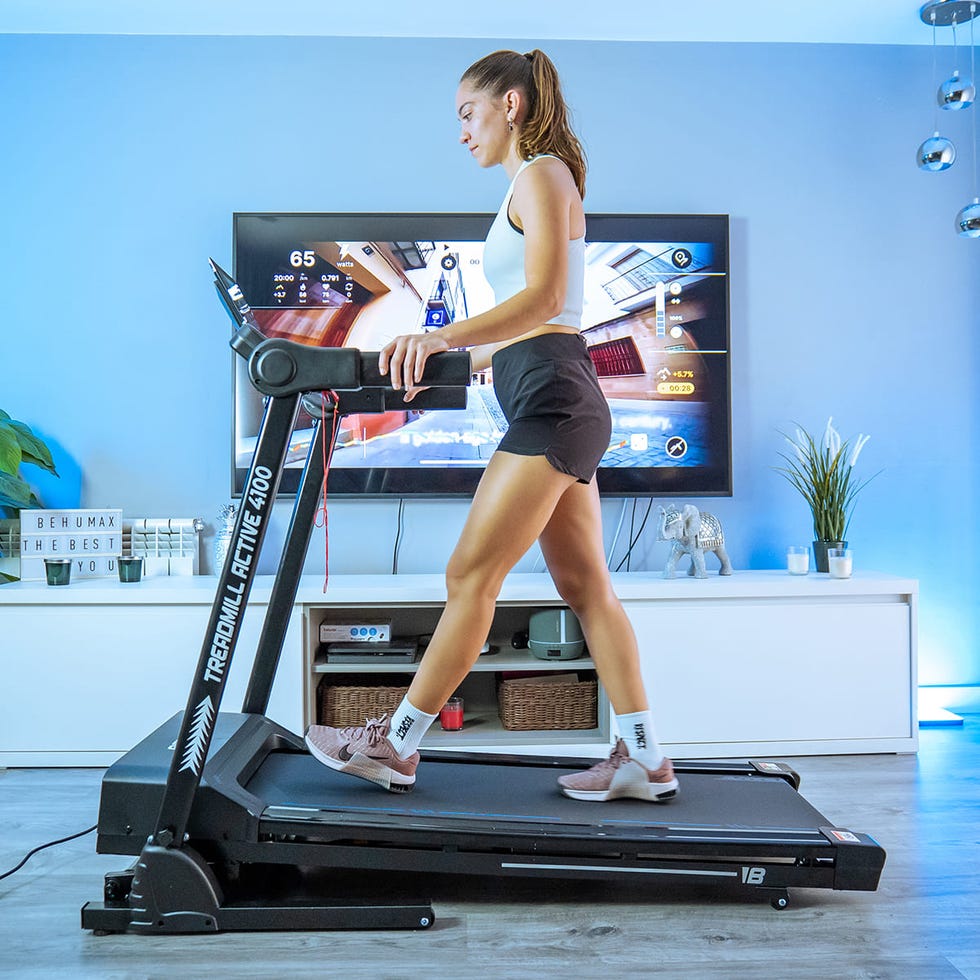 person walking on a treadmill in a modern home gym