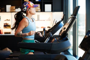 individual exercising on a treadmill in a modern gym