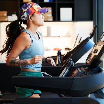 individual exercising on a treadmill in a modern gym individual exercising on a treadmill in a modern gym