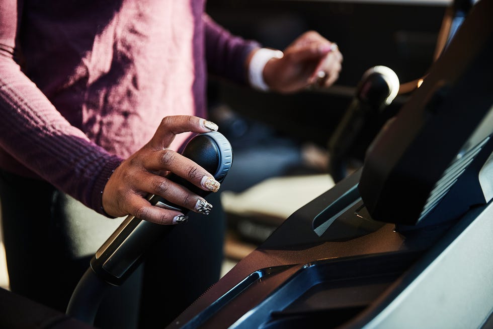 closeup of a hand gripping a control on exercise equipment