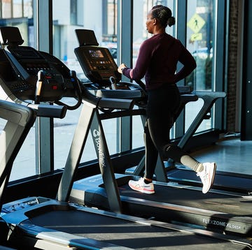 Individual running on a treadmill in a gym setting individual running on a treadmill in a gym setting