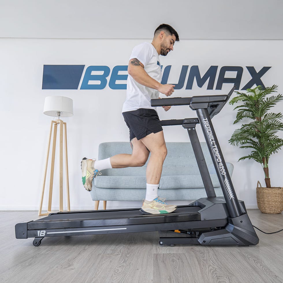 person jogging on a treadmill in a modern living space