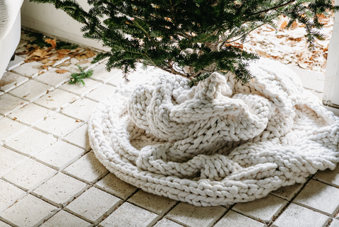 cable knit blanket wrapped around a tree
