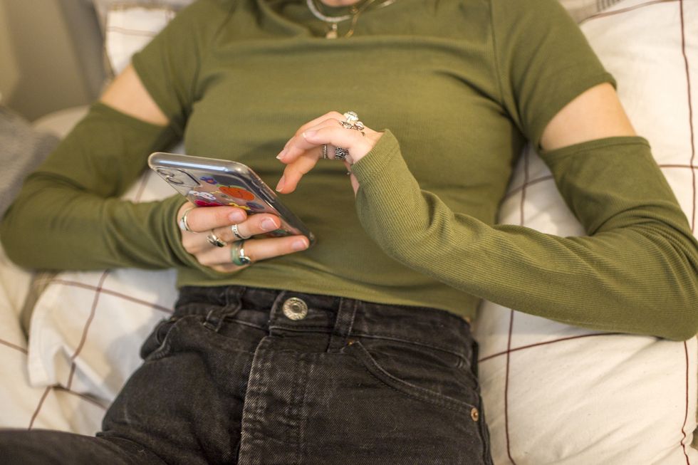 teenage girl looking her mobile phone at home