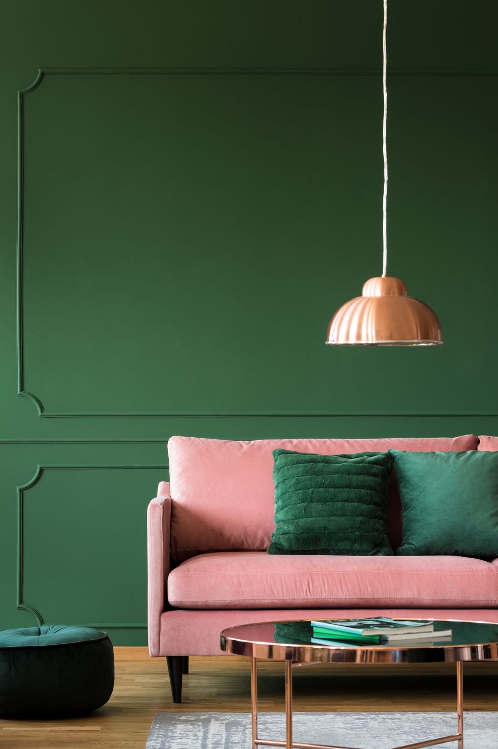 green living room with pink velvet sofa