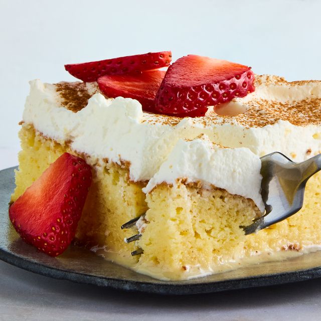 tres leches cake topped with whipped cream and cinnamon