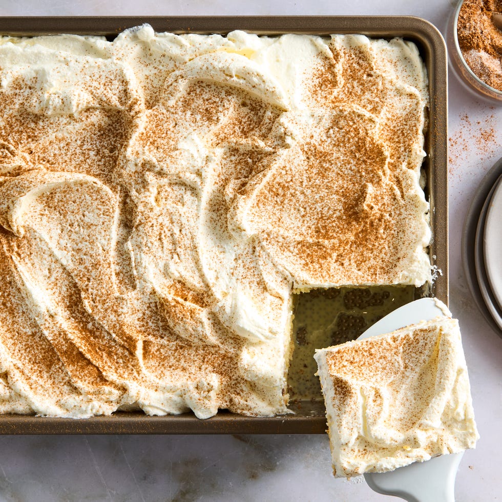 tres leches cake topped with whipped cream and cinnamon
