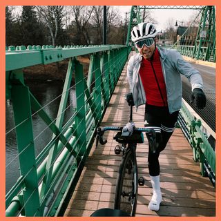 Trevor Raab crossing a bridge with his bike.