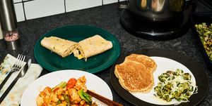 kung pao chicken, chicken enchilada, pancakes and egg, spinach and mushrooms on plates