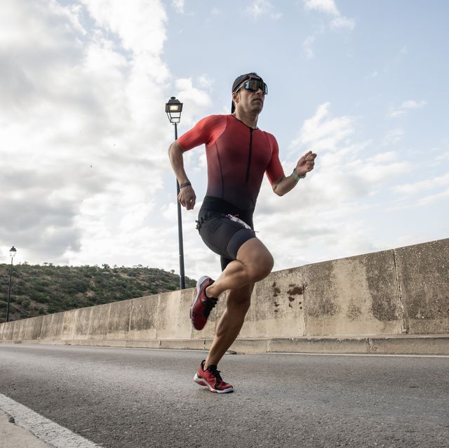 triathlete training leg strength and running on a bridge