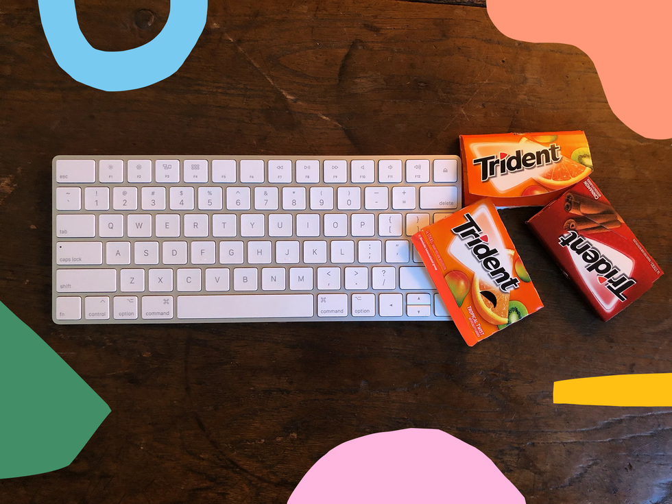 trident gum packs sitting on desk next to computer keyboard