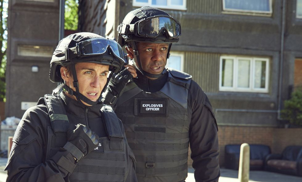 trigger point pictured vicky mcclure and adrian lester in  black body armour with mcclure on the radio