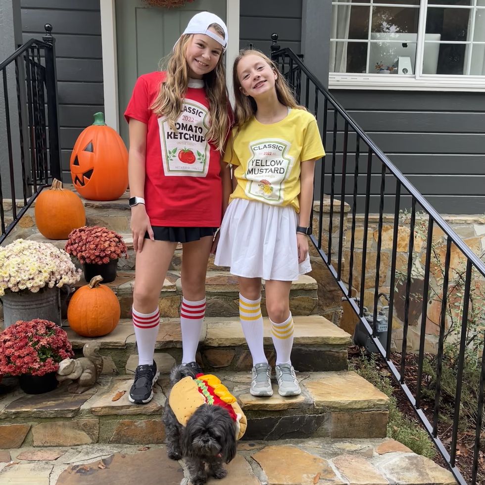 halloween costumes of two girls in ketchup and mustard t shirts and dog in a hot dog outfit