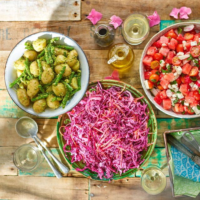 a trio of vibrant summer salads in an outdoor setting