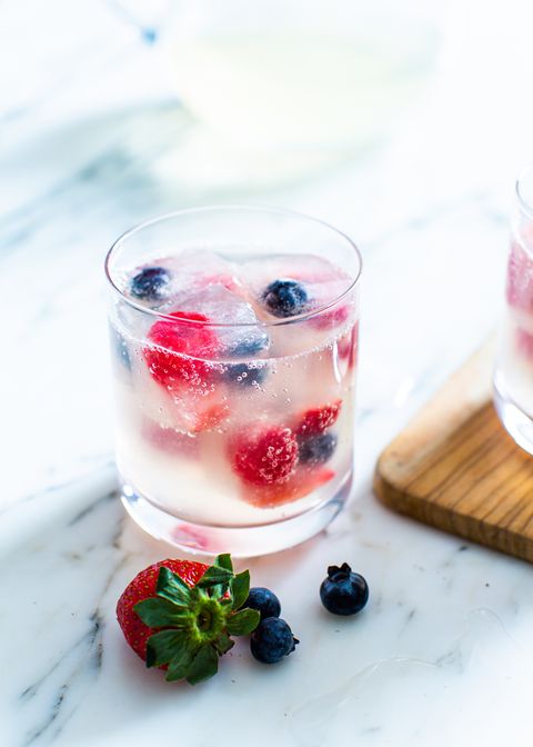 triple berry sparkler mocktail with berry ice cubes in a glass