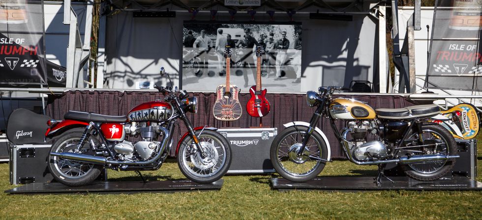 triumphs at 2023 barber vintage festival parked in grass with guitars behind it
