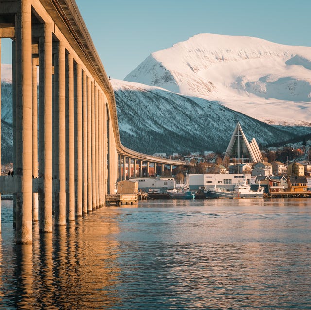 a bridge over water with a city in the background