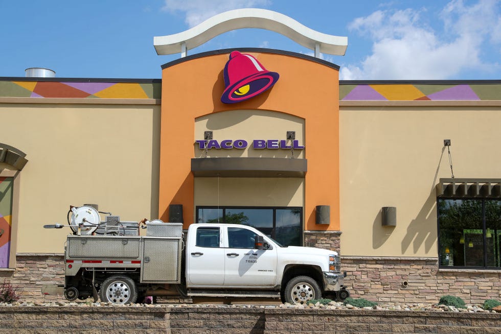 a truck is seen at the drive thru window of a taco bell fast