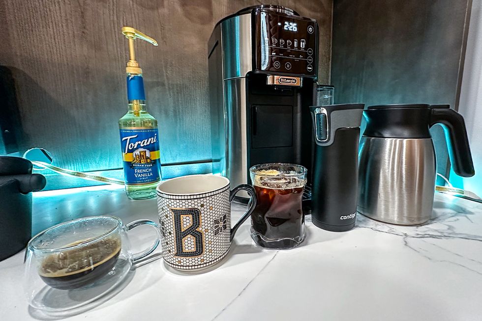 truebrew coffee maker with a variety of drinks it is capable of making set on a counter