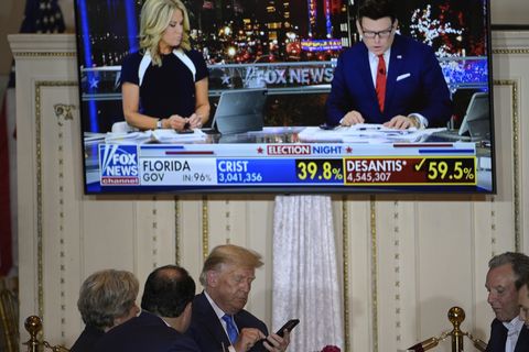 palm beach, fl november 8 former president donald trump, center, check his phone while watching results with guests during an election night party at mar a lago, tuesday, november 8, 2022 in palm beach, florida phelan m ebenhack for the washington post via getty images